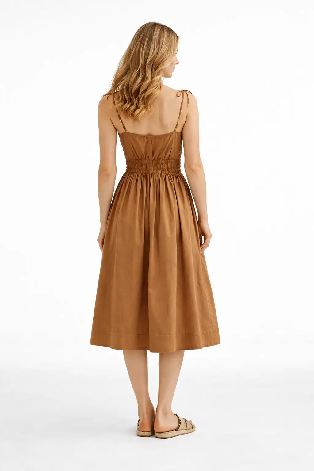 Woman wearing a brown dress on a white background