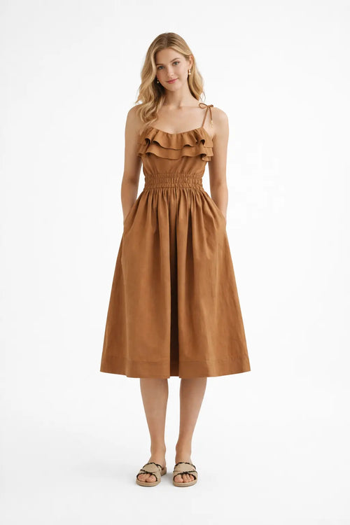 Woman wearing a brown dress on a white background